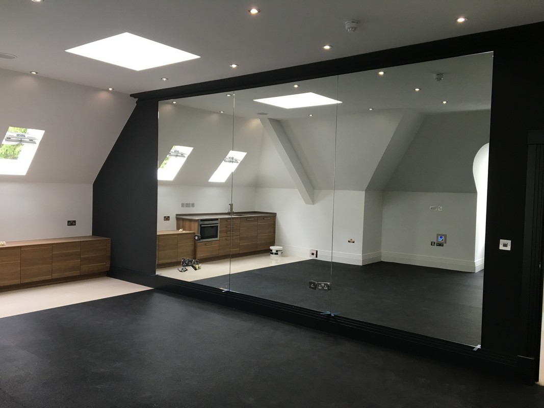 Frameless glass wall dividing loft conversion in Elephant & Castle